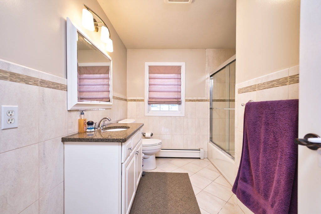 52 Pershing Avenue Acushnet, MA 02743 - Photo 18 of 27 a bathroom with a sink a toilet and tub