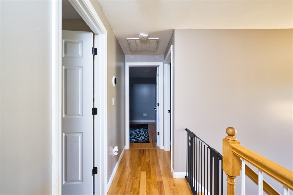 52 Pershing Avenue Acushnet, MA 02743 - Photo 19 of 27 a view of a hallway with wooden floor and a bathroom
