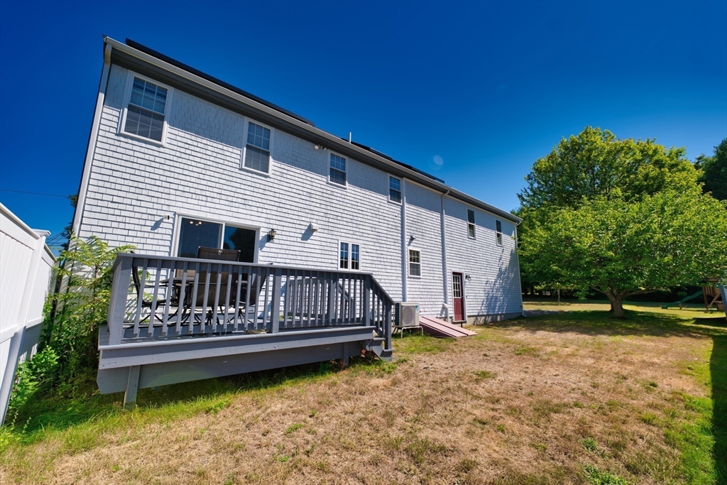 52 Pershing Avenue Acushnet, MA 02743 - Photo 7 of 27 a view of a house with wooden deck and furniture