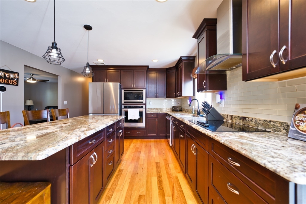 52 Pershing Avenue Acushnet, MA 02743 - Photo 8 of 27 a large kitchen with granite countertop a sink counter space and stainless steel appliances