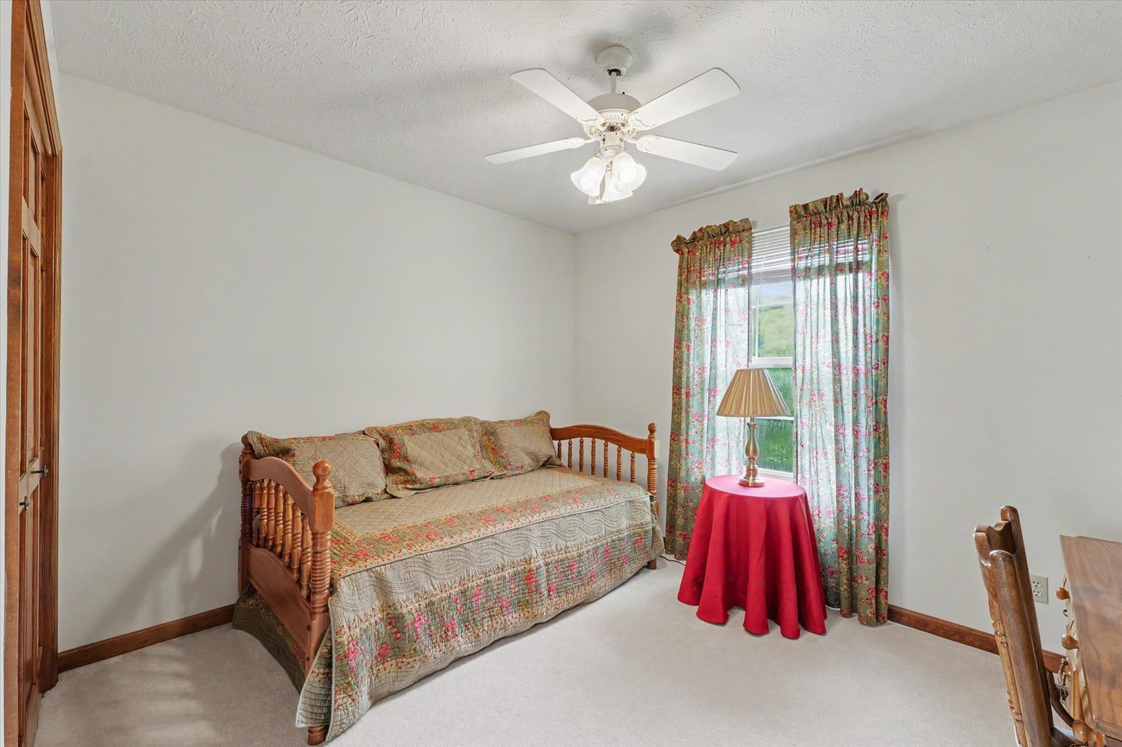 4409 Copper Ridge Road Champaign, IL 61822 - Photo 29 of 40 a bedroom with a bed and a chandelier