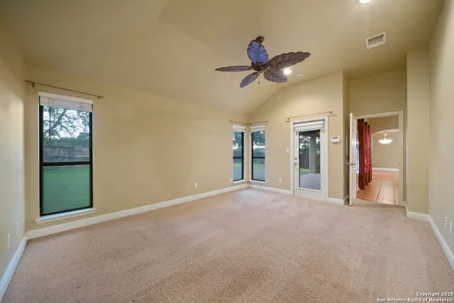 a view of a livingroom with a ceiling fan and window