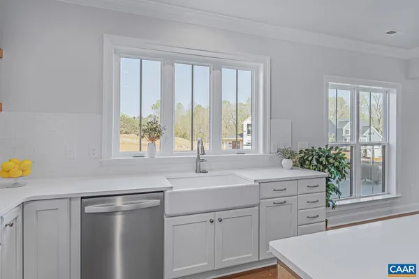 a kitchen with a sink cabinets and window