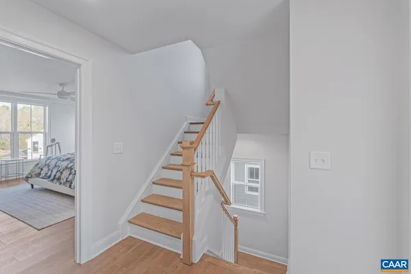 a view of entryway and hall with wooden floor