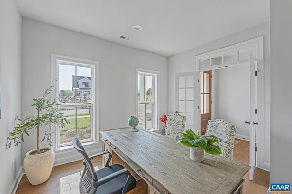 a room with furniture and potted plant