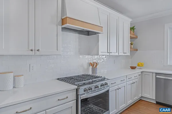 a kitchen with white cabinets and white appliances