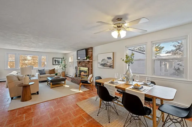a view of a dining room with furniture a chandelier and wooden floor
