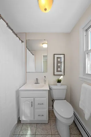 a bathroom with a sink toilet vanity and shower
