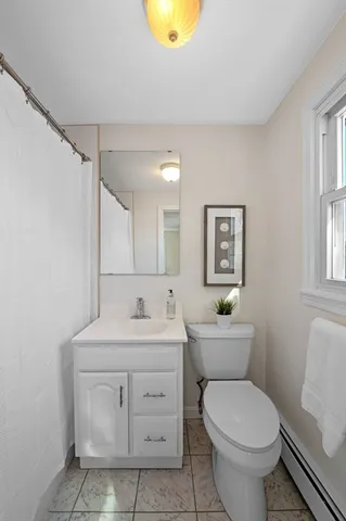 a bathroom with a sink toilet vanity and shower