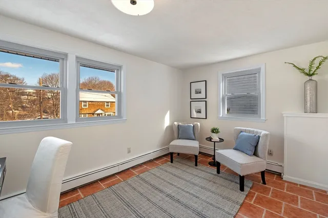 a workspace with wooden floor and a window