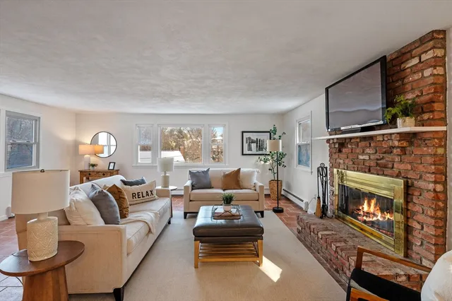 a living room with furniture and a fireplace