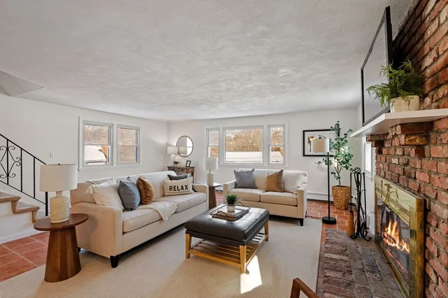 a living room with furniture a chandelier and a dining table