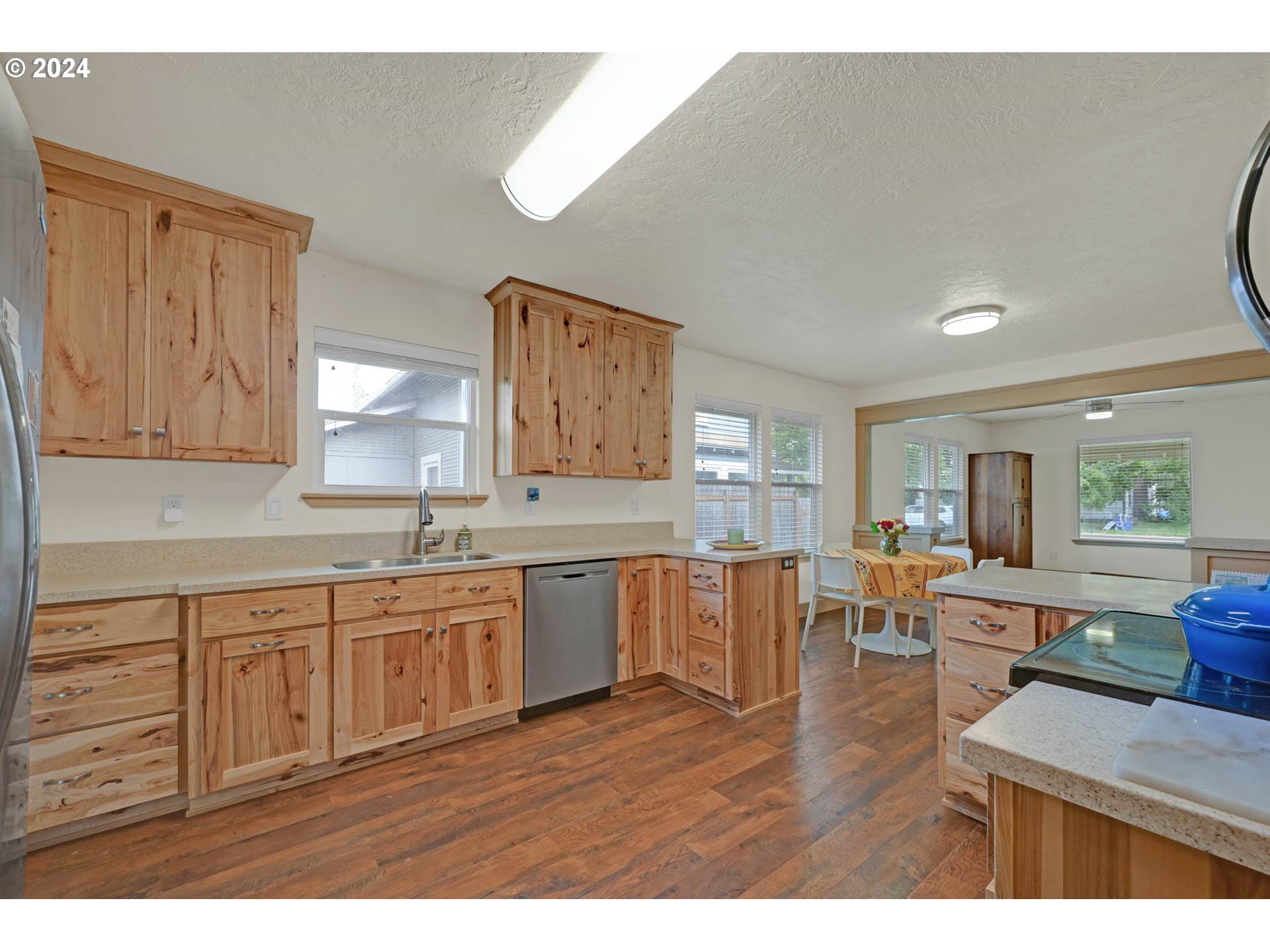 830 G Street Springfield, OR 97477 - Photo 13 of 38 a open kitchen with granite countertop a sink dishwasher stove and cabinets with wooden floor