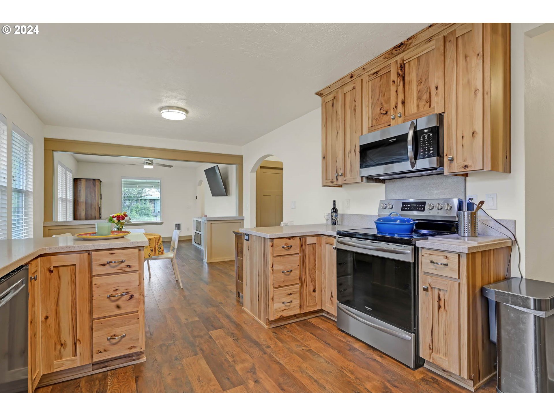 830 G Street Springfield, OR 97477 - Photo 14 of 38 a kitchen with stainless steel appliances granite countertop a stove a sink dishwasher and a microwave oven with white cabinets