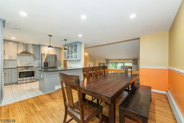 a dining room with furniture and wooden floor