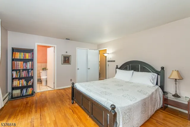 a bedroom with a bed and a wooden floor