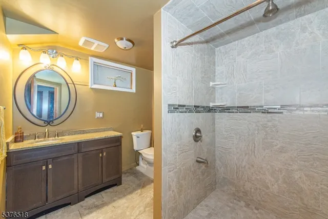 a bathroom with a sink a mirror and a shower