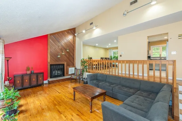 a living room with furniture pool table and a fireplace