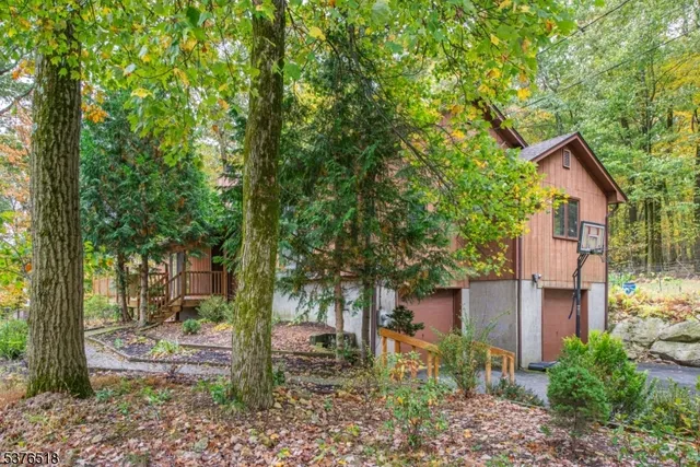 a view of a house with a tree in the yard