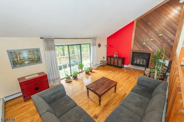 a living room with furniture a large window and a flat screen tv
