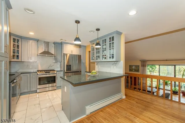 a kitchen with stainless steel appliances granite countertop a stove and a sink