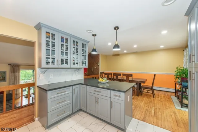 a kitchen with a sink stove and wooden floor