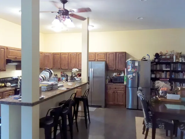 a kitchen with refrigerator and cabinets