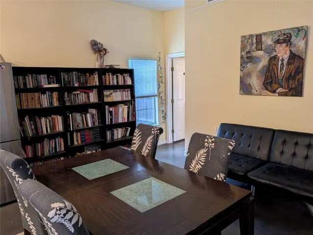 a living room with furniture and a book shelf