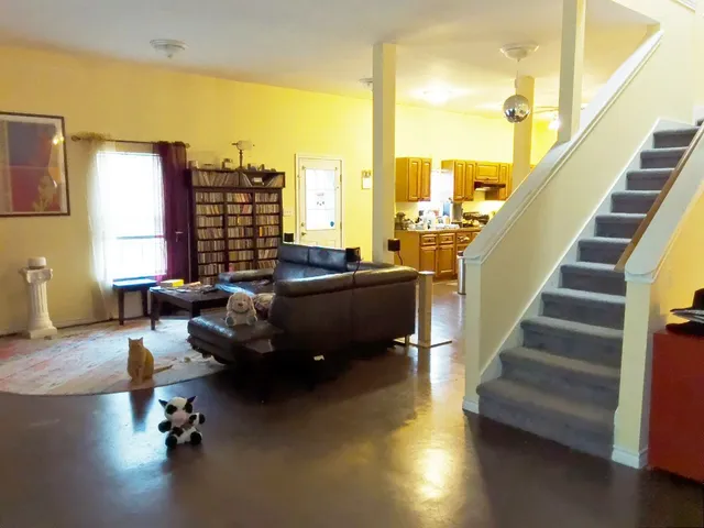 a living room with furniture wooden floor and a table