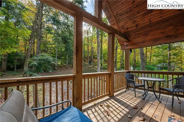 a view of balcony with wooden floor and outdoor seating