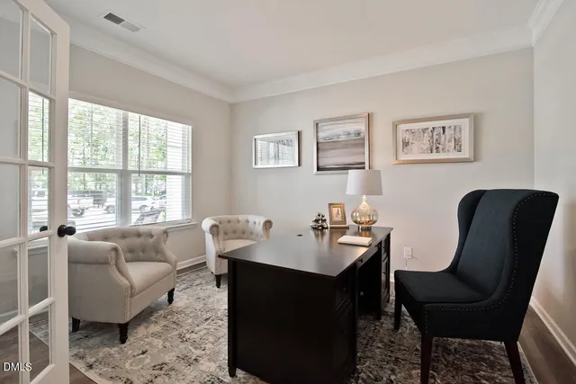 a living room with furniture a table and a large window