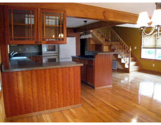 436 Spring Street Hanson, MA 02341 - Photo 3 of 24 a kitchen with stainless steel appliances granite countertop a refrigerator a stove and a microwave with wooden floor