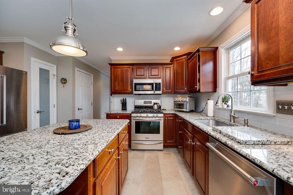 36 Pickwick Place Birdsboro, PA 19508 - Photo 25 of 72 a kitchen with stainless steel appliances granite countertop a sink stove and refrigerator