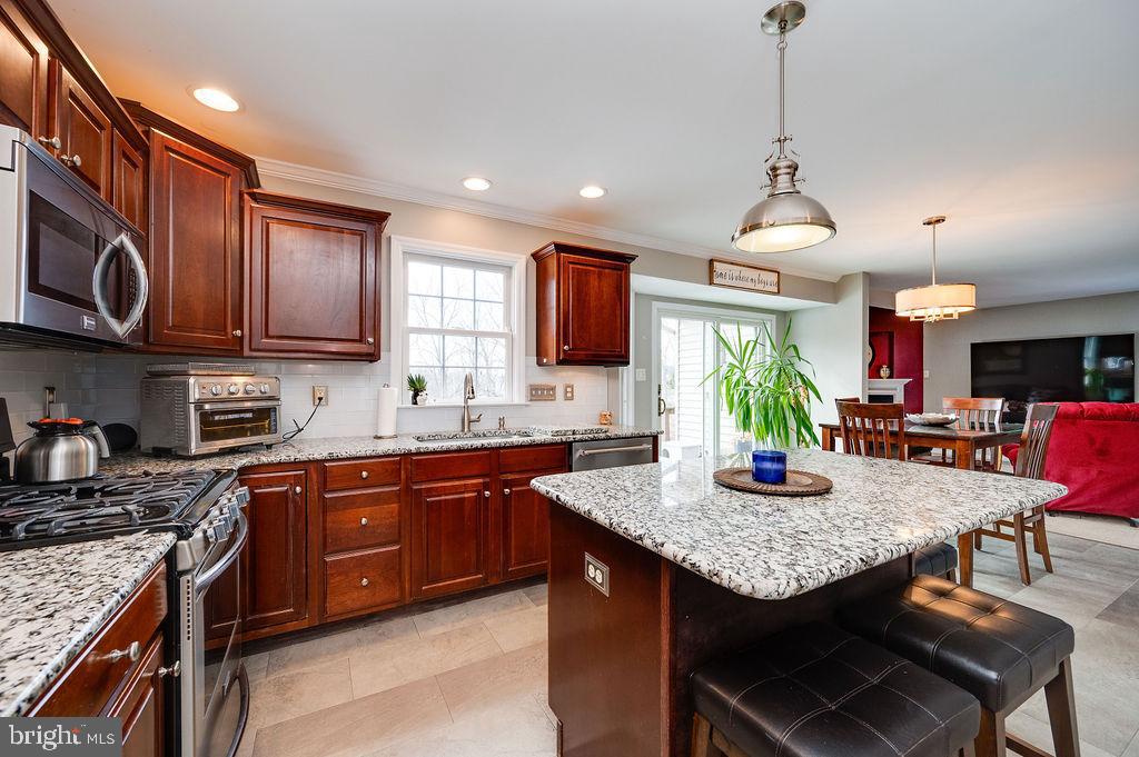 36 Pickwick Place Birdsboro, PA 19508 - Photo 26 of 72 a kitchen with granite countertop kitchen island stainless steel appliances a sink stove and cabinets