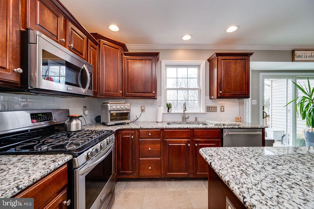 36 Pickwick Place Birdsboro, PA 19508 - Photo 27 of 72 a kitchen with stainless steel appliances granite countertop wooden cabinets stove top oven and sink