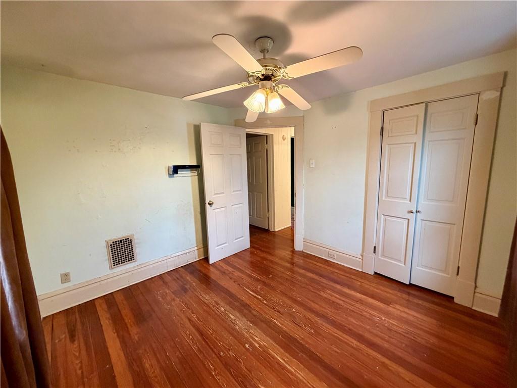 118 Ida Avenue Donora, PA 15033 - Photo 12 of 18 an empty room with wooden floor fan and windows