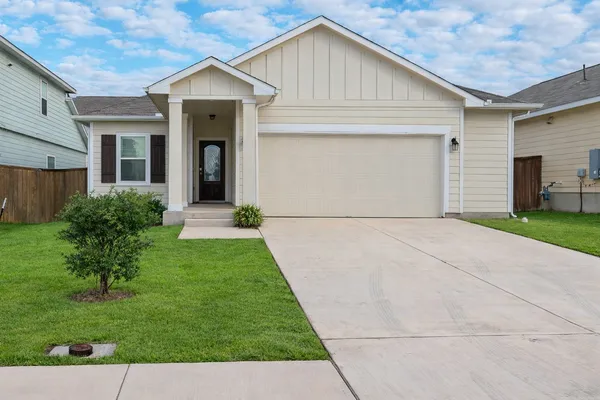 a front view of house with yard and green space