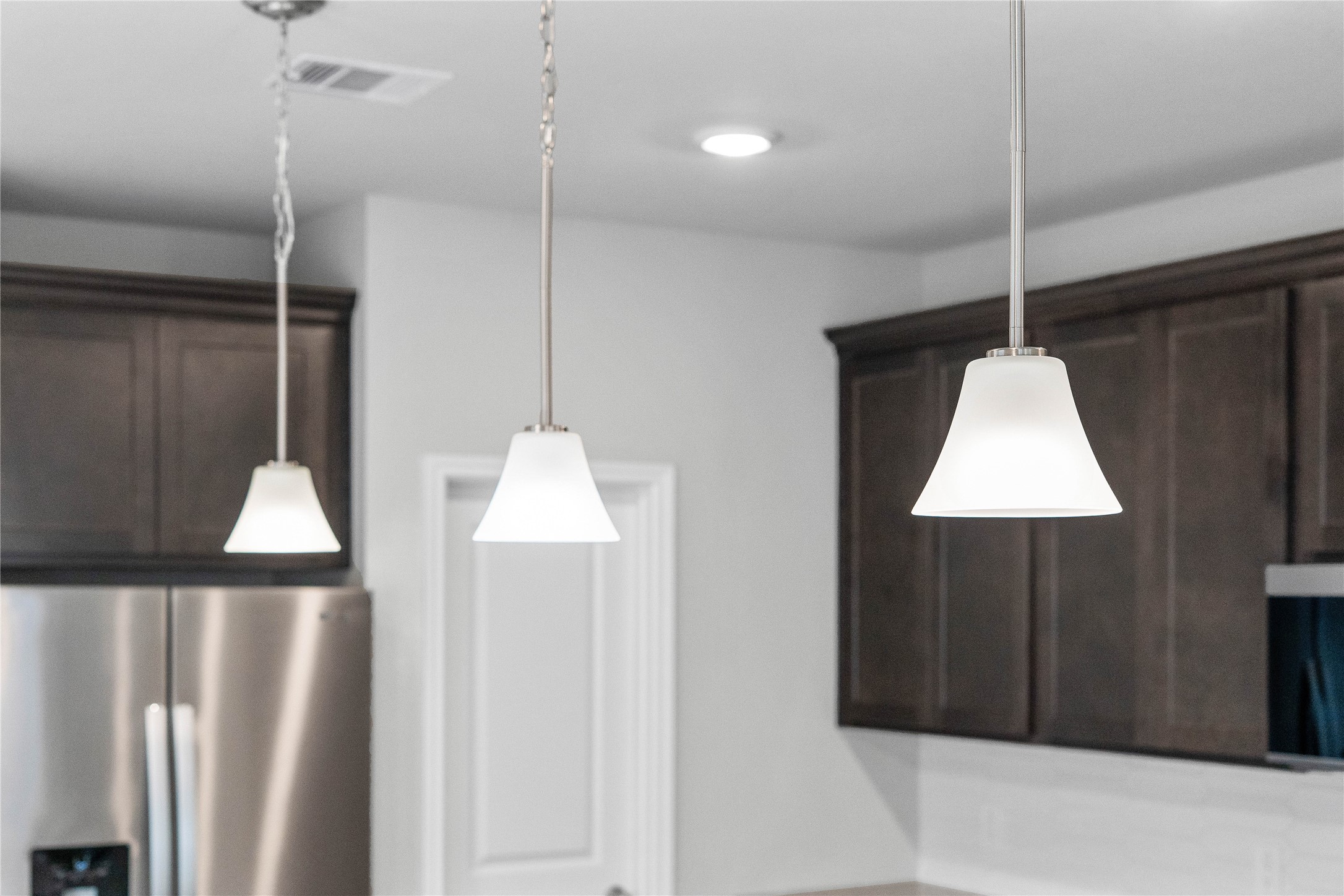 19555 Montgomery Rdg Way Montgomery, TX 77316 - Photo 21 of 38 Style Pendants Brushed Nickel lights that hang over the kitchen island.