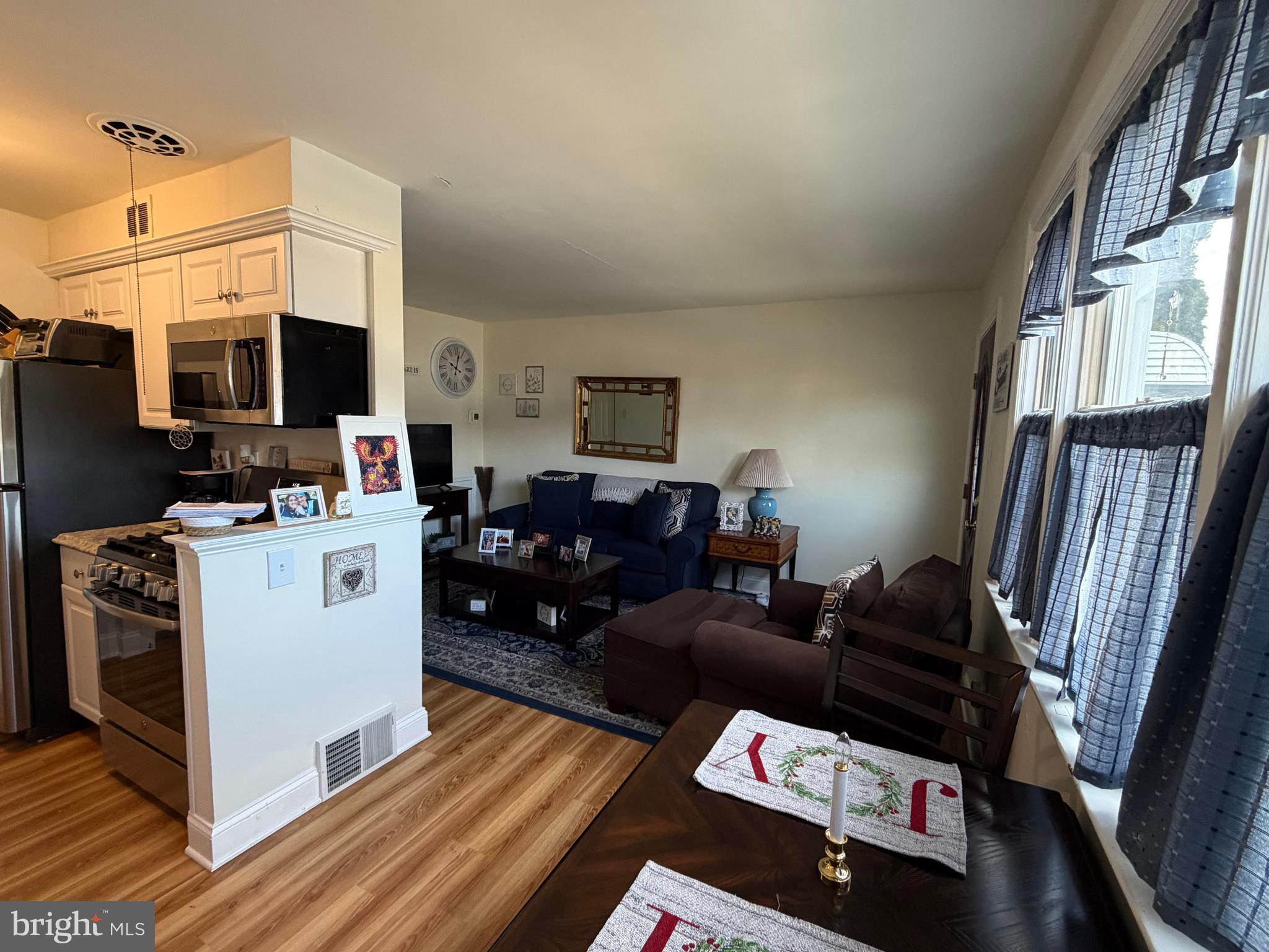 734 Primos Avenue Clifton Heights, PA 19018 - Photo 6 of 16 a living room with furniture a flat screen tv and a fireplace