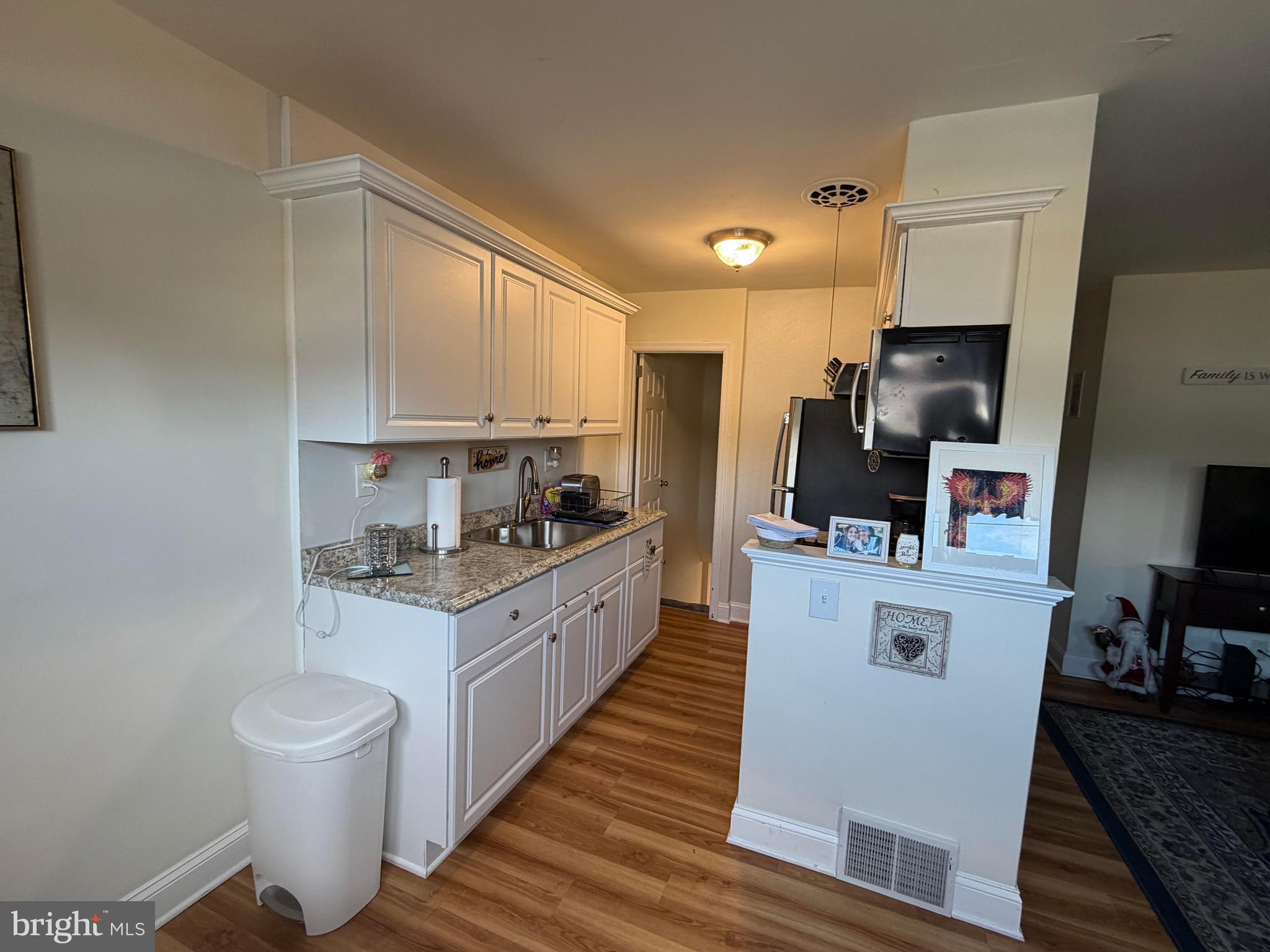 734 Primos Avenue Clifton Heights, PA 19018 - Photo 8 of 16 a kitchen with sink a microwave and cabinets