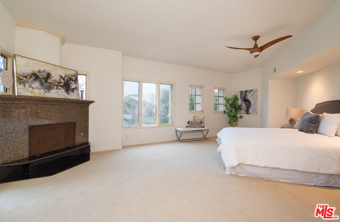 115 Roma Court Marina del Rey, CA 90292 - Photo 28 of 59 a spacious bedroom with a bed and a fireplace