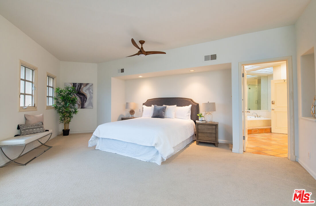 115 Roma Court Marina del Rey, CA 90292 - Photo 29 of 59 a bedroom with a bed and potted plant