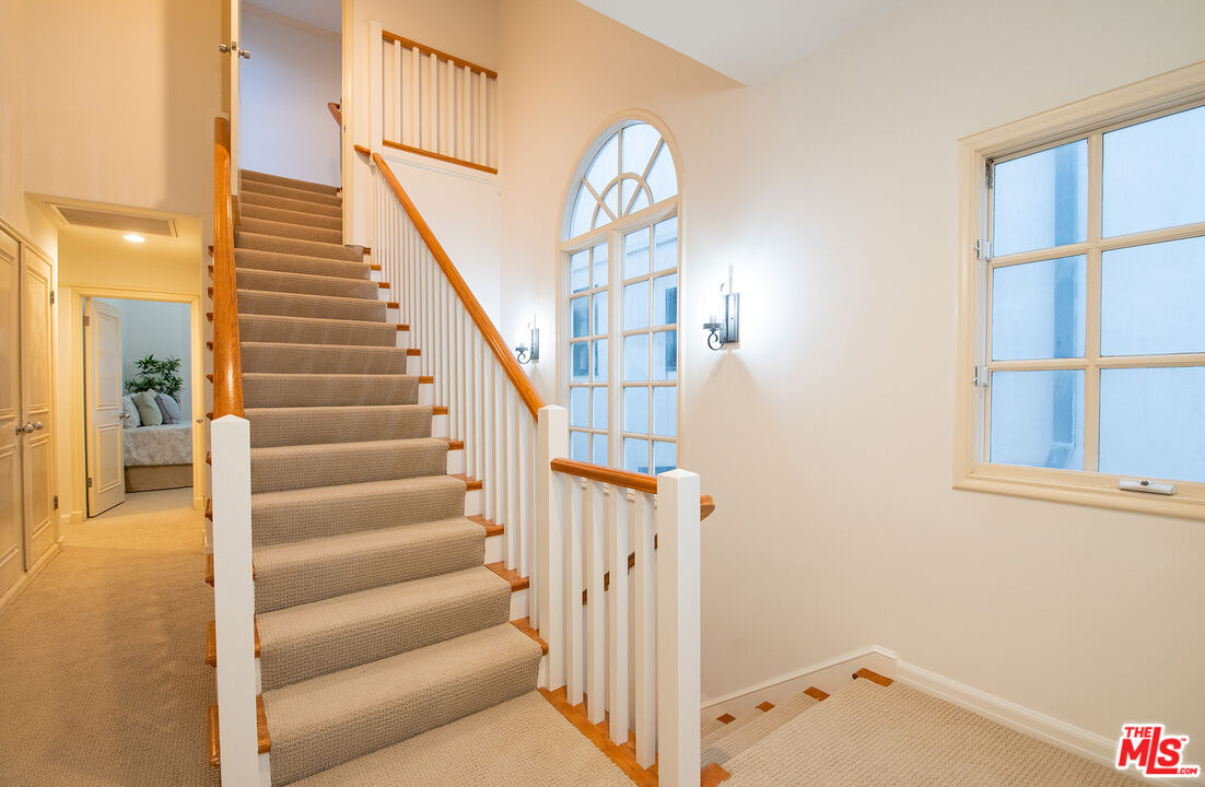 115 Roma Court Marina del Rey, CA 90292 - Photo 33 of 59 a view of staircase with white walls and a window