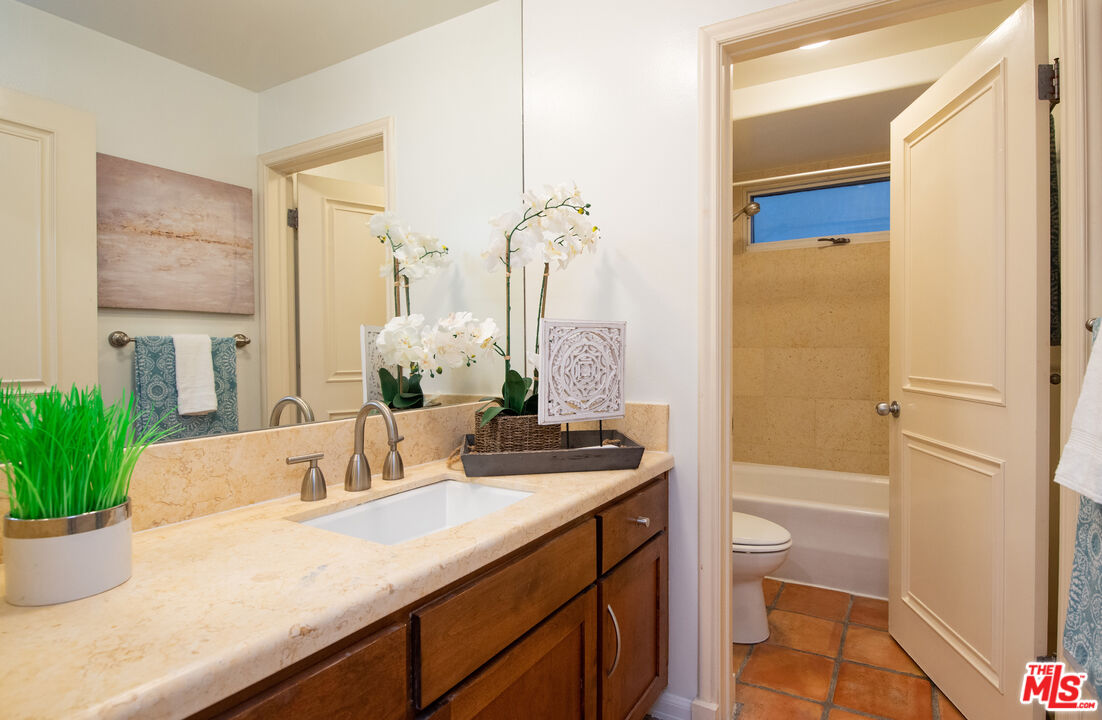 115 Roma Court Marina del Rey, CA 90292 - Photo 34 of 59 a bathroom with a granite countertop sink a toilet and tub