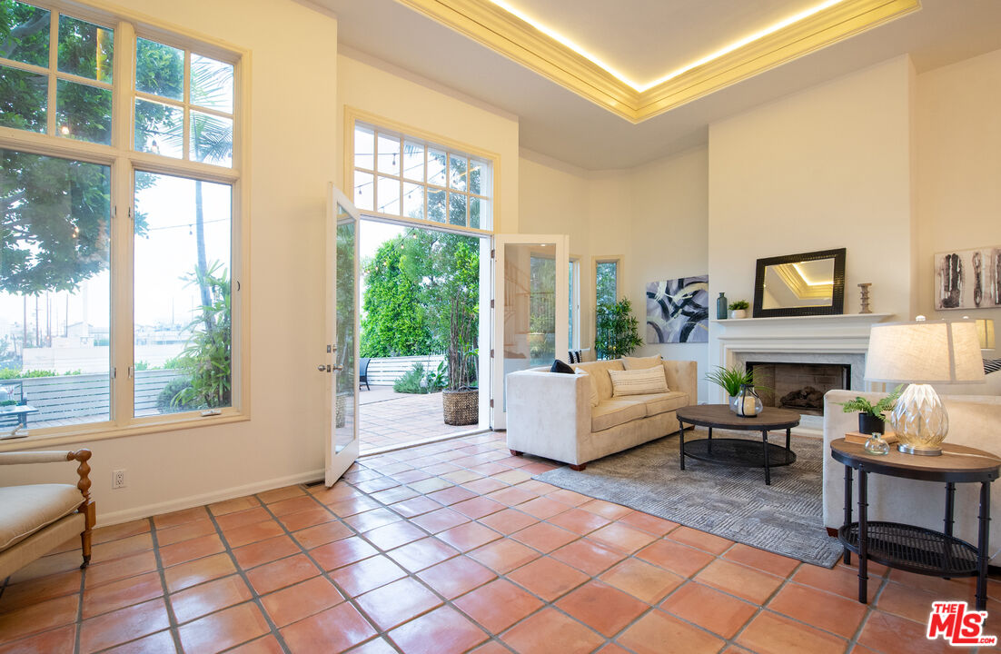115 Roma Court Marina del Rey, CA 90292 - Photo 6 of 59 a living room with furniture a large window and a fireplace