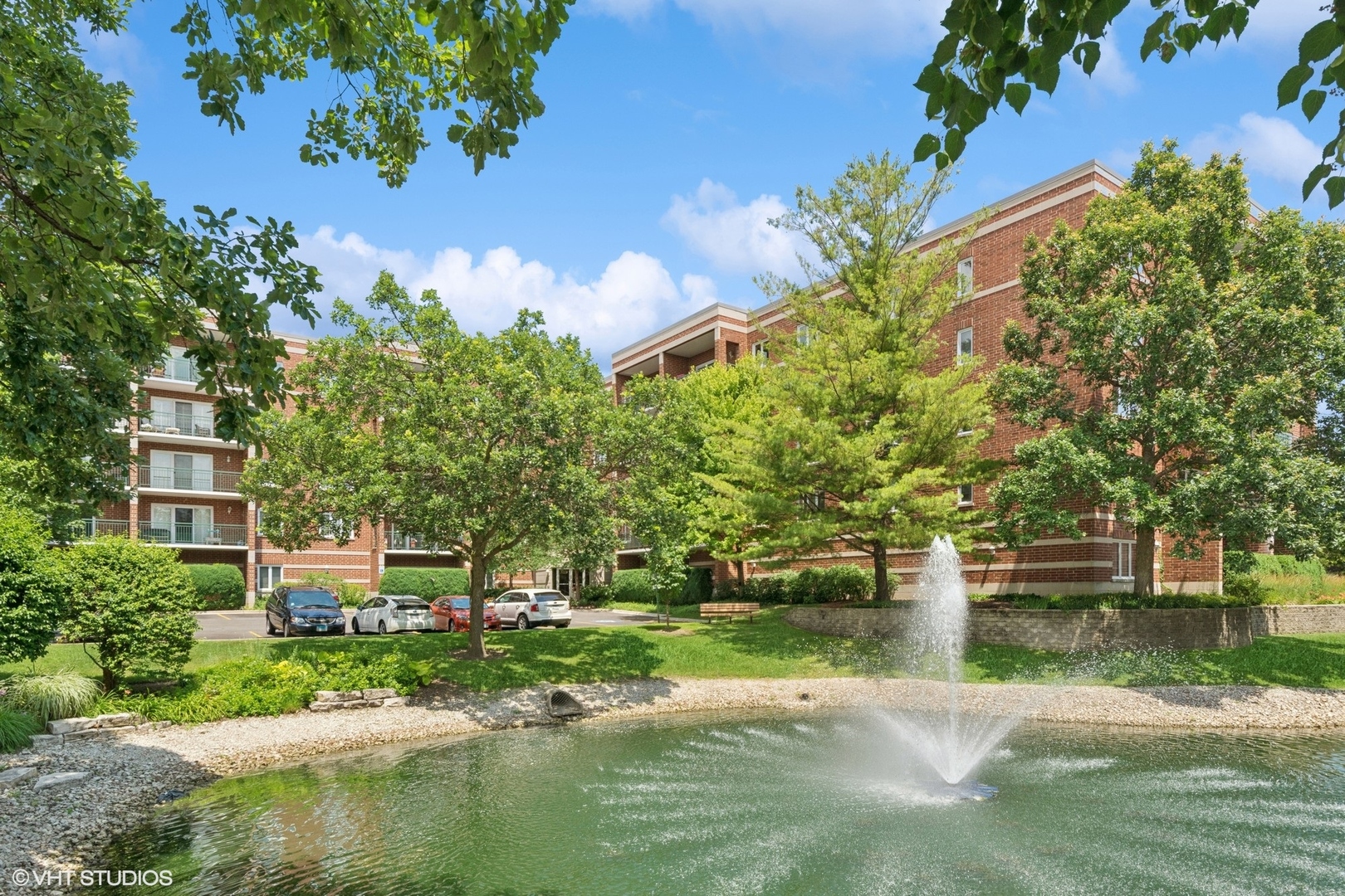 5225 North Riversedge Terrace, Unit 511 Chicago, IL 60630 - Photo 1 of 16 a view of a house with a yard and a water fountain