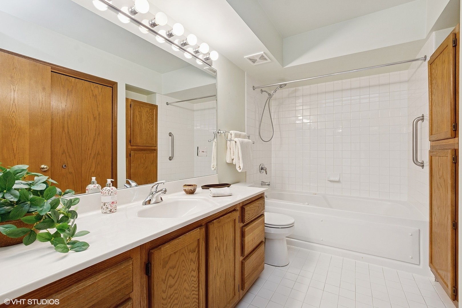 5225 North Riversedge Terrace, Unit 511 Chicago, IL 60630 - Photo 11 of 16 a bathroom with a sink a toilet and shower