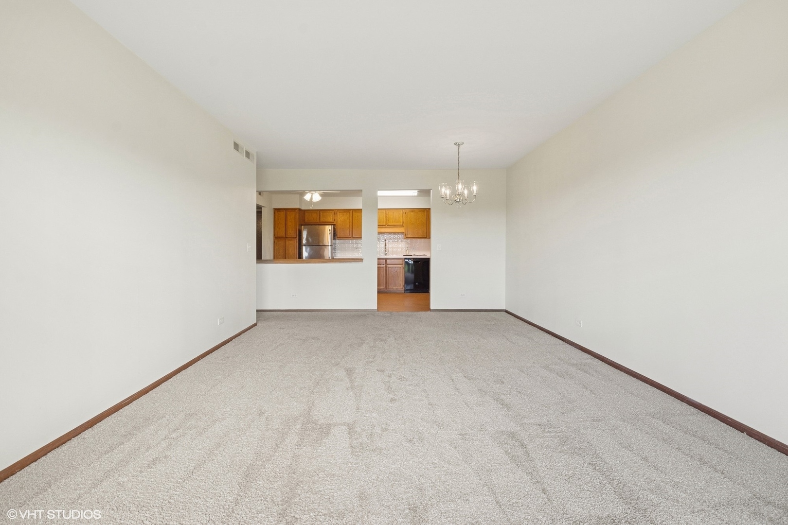 5225 North Riversedge Terrace, Unit 511 Chicago, IL 60630 - Photo 4 of 16 an empty room with windows