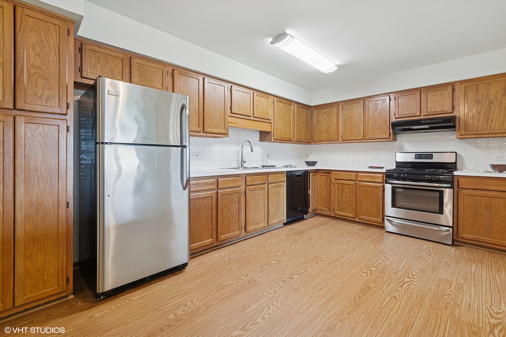 5225 North Riversedge Terrace, Unit 511 Chicago, IL 60630 - Photo 5 of 16 a kitchen with stainless steel appliances granite countertop a refrigerator sink and cabinets