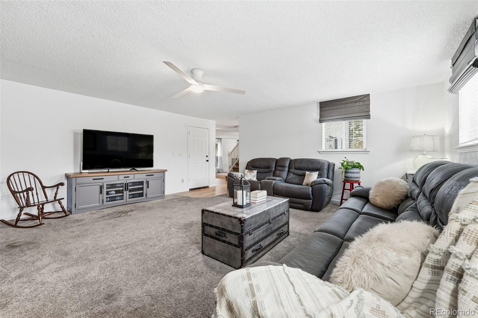 4993 East 111th Place Thornton, CO 80233 - Photo 13 of 50 a living room with furniture and a flat screen tv
